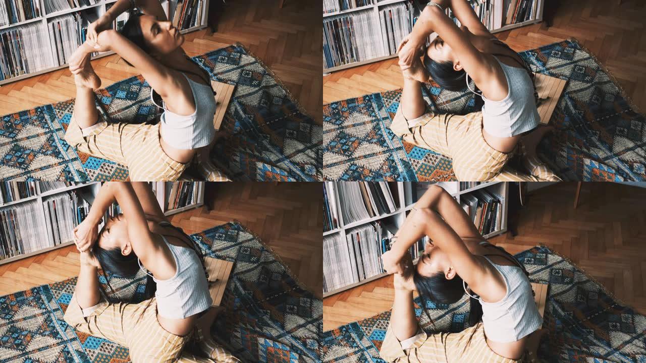 一个年轻女子在家里练习瑜伽时做高级鸽子姿势的特写镜头