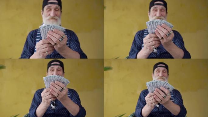 迷人微笑的前视图富有时尚的大胡子老人手里拿着美元钞票