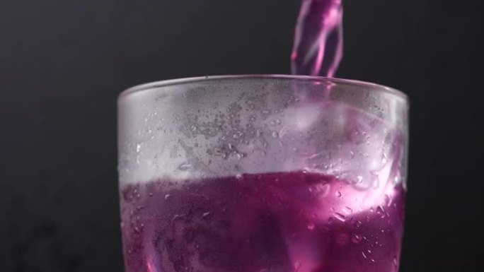 一杯葡萄汁。将葡萄汁倒入加冰的玻璃杯中。用葡萄汁填充玻璃杯