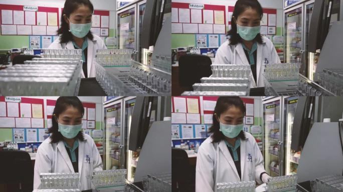 医疗技术人员正在献血室内使用血液分析机。