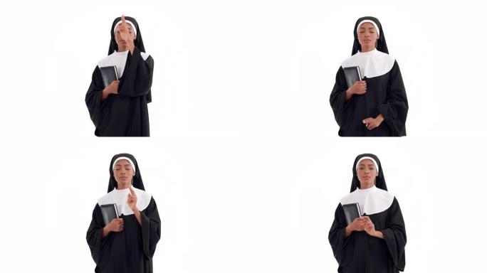 非洲修女拿着圣经，对着镜头做祝福手势的肖像。孤立在白色背景上。基督教概念。