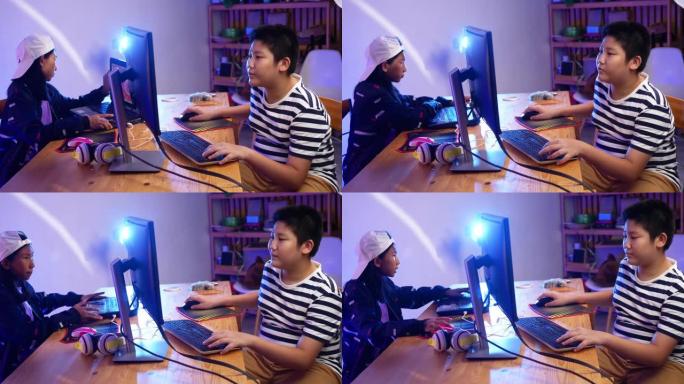 两个孩子在家里晚上用led灯一起玩网络游戏。男孩和女孩玩充分的情感，生活方式的概念。