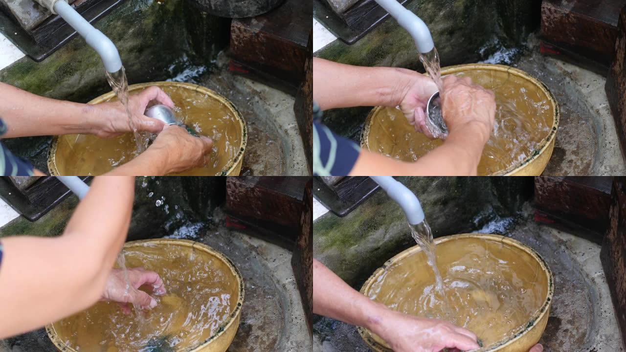 女人的手在肮脏的厨房里洗越南咖啡过滤器