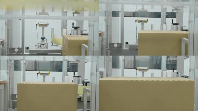 带药丸的纸板箱在制药厂车间的金属自动线上移动。制药化学公司工作过程中药物沿传送带移动的特写视图