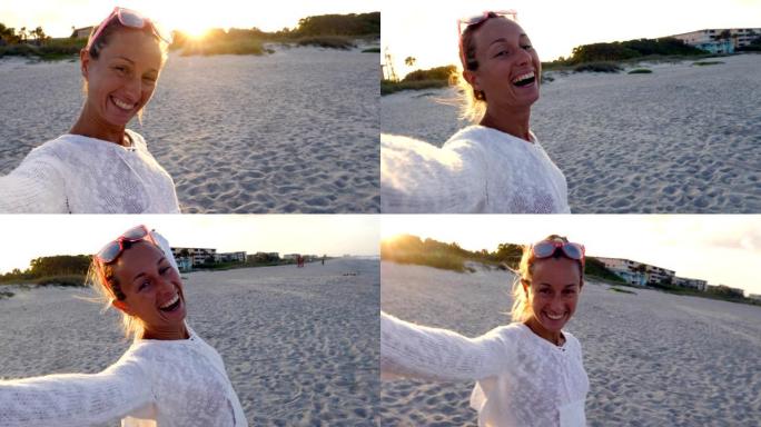 海滩上的幸福女人在日落时自拍肖像用手机在线聊天