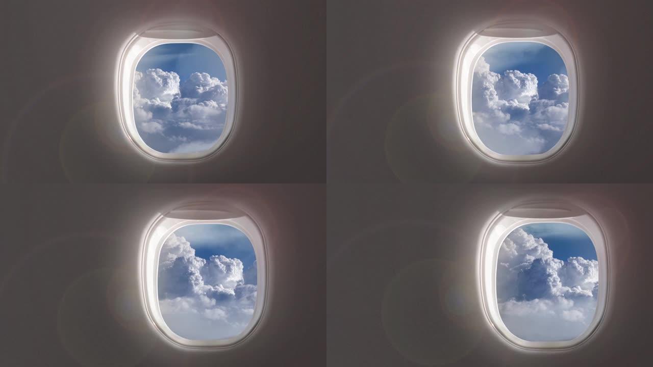 飞机窗户上有4k的蓝天视频，飞机内部有多云的鸟瞰图。