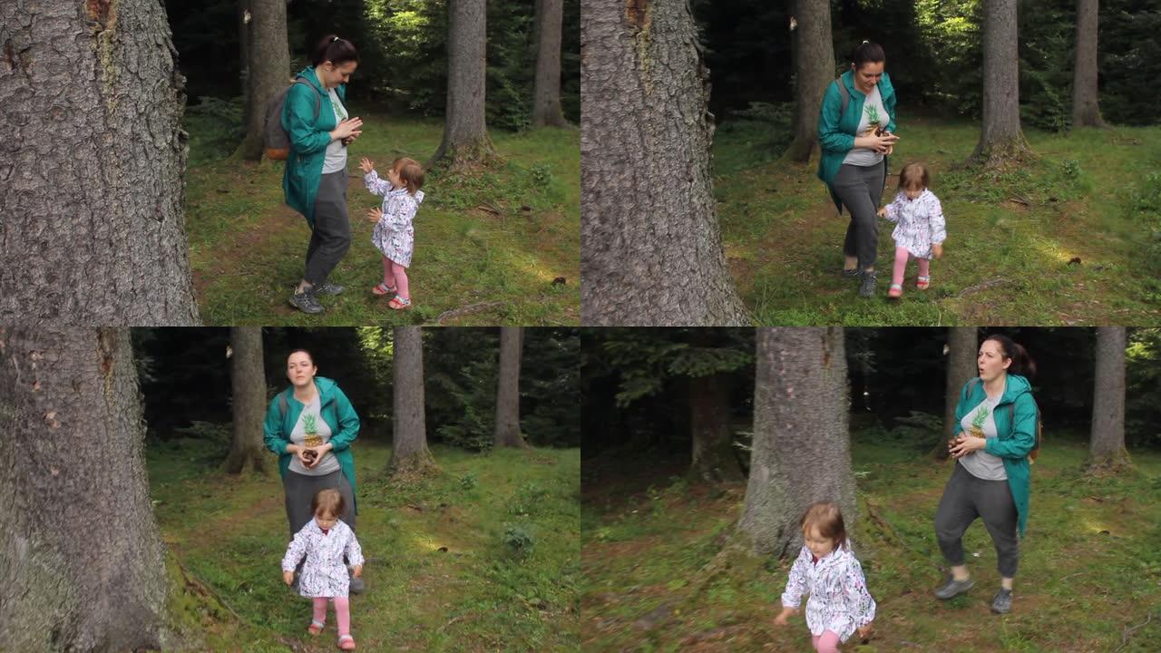 带着孩子的女人旅行者，在森林里散步。