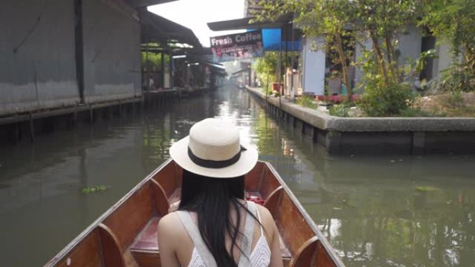 慢动作美丽的亚洲女性游客戴着帽子坐在泰国曼谷丹诺萨杜阿克的行旅行出租车船景点。