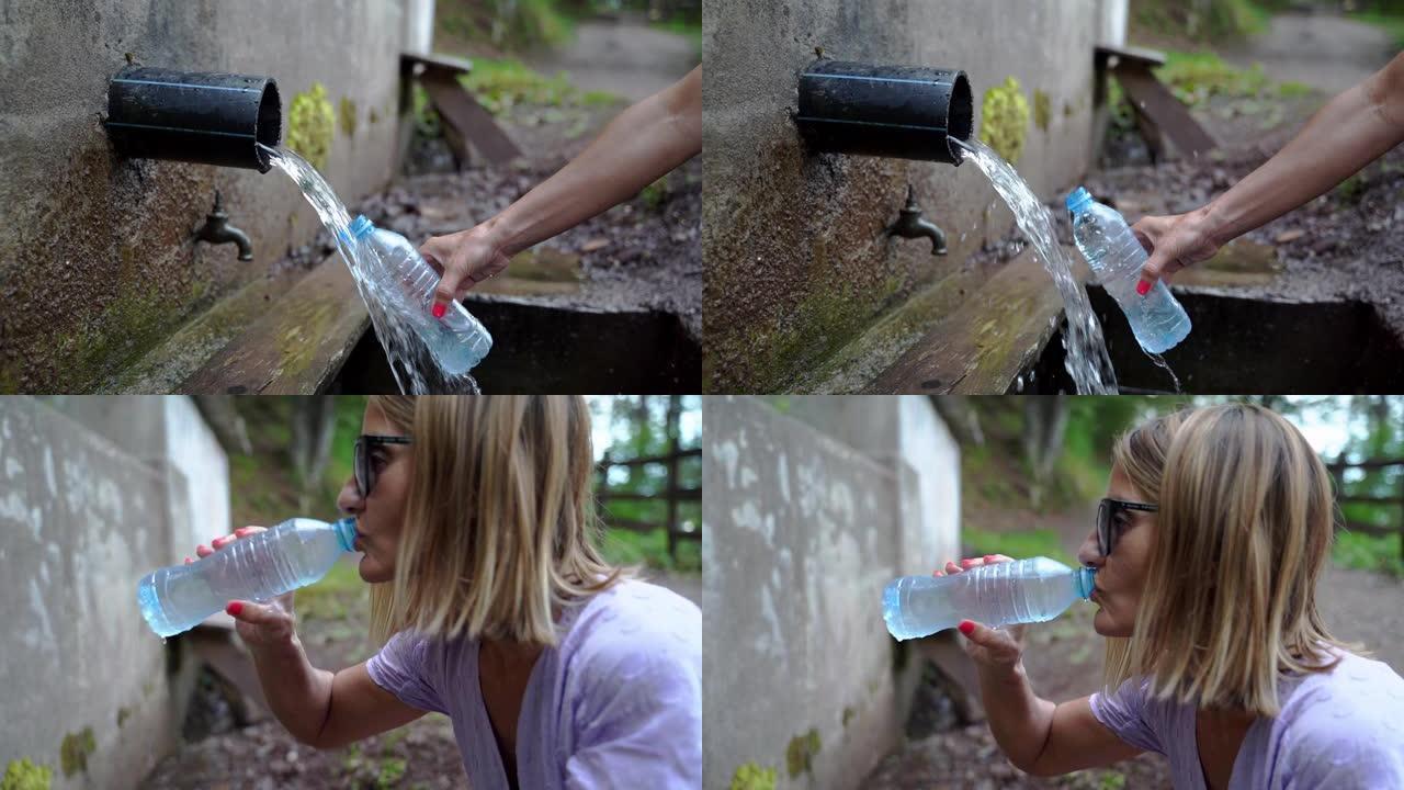 侧视图高加索妇女从塑料瓶中的山泉取水并饮用-侧视图