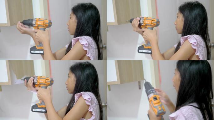 亚洲女孩在家用螺丝刀打结，DIY概念。