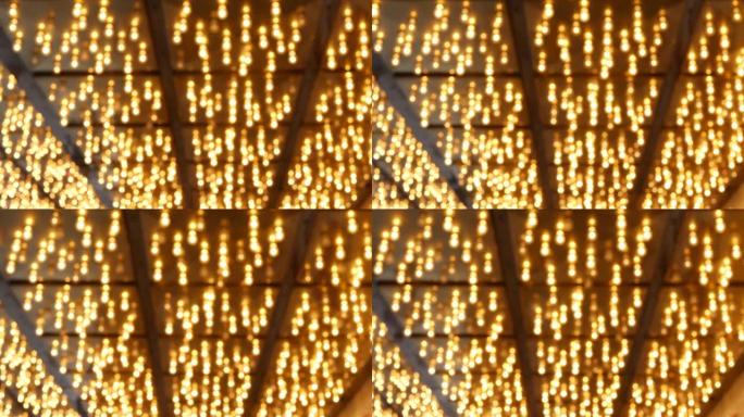 散焦的旧时尚电灯在晚上发光。美国拉斯维加斯模糊复古赌场装饰的抽象特写。发光复古风格灯泡在弗里蒙特街上