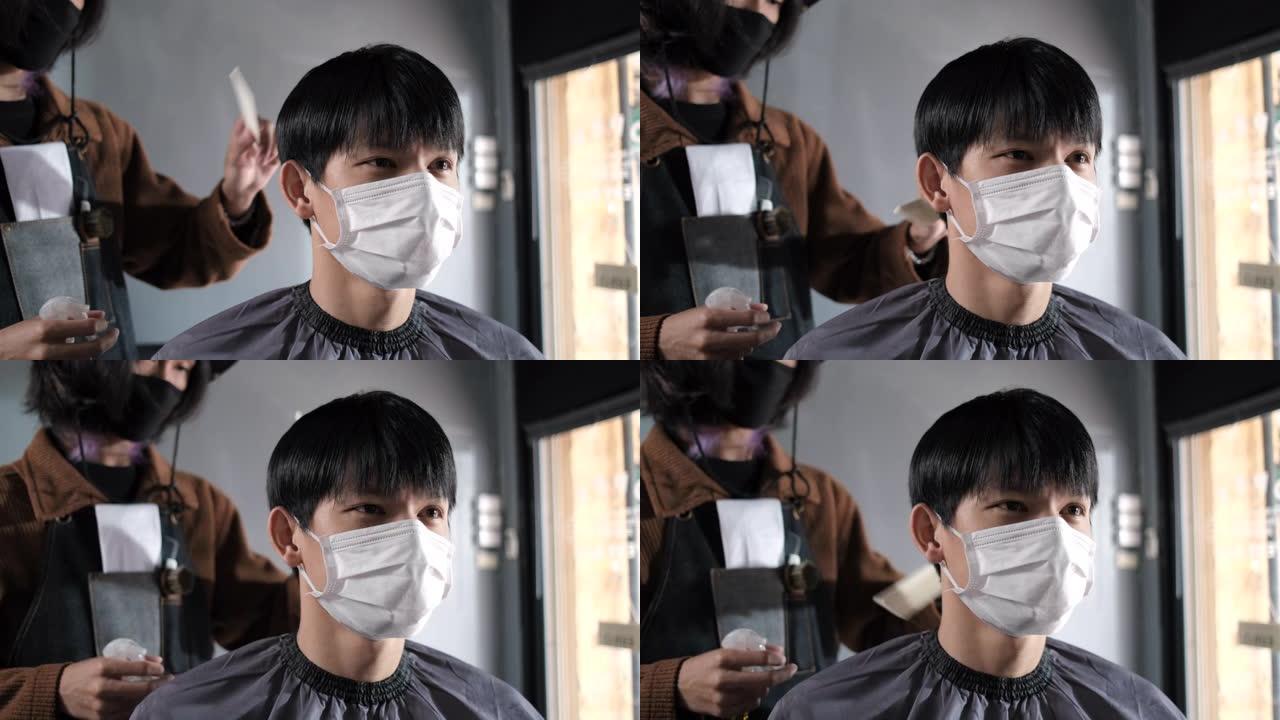 亚洲理发店理发排队客户戴口罩预防业务在covonarirus锁定后重新开放，男士发型设计和新的正常生