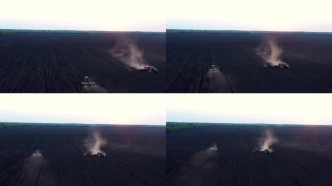 在刮风的春天，播种机在大片田地工作的拖拉机的鸟瞰图