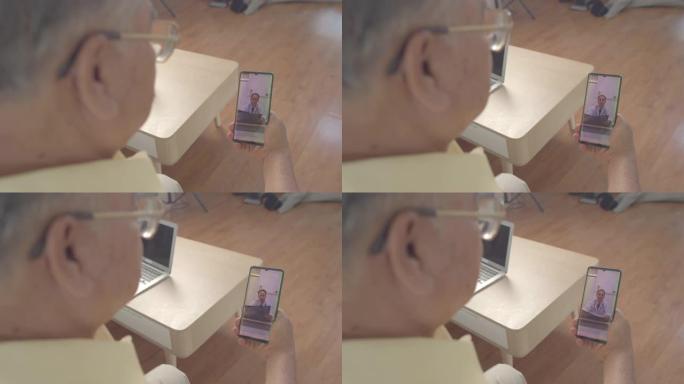 高加索男子医生通过手机视频通话谈论亚洲祖父母的健康。家庭保健概念。