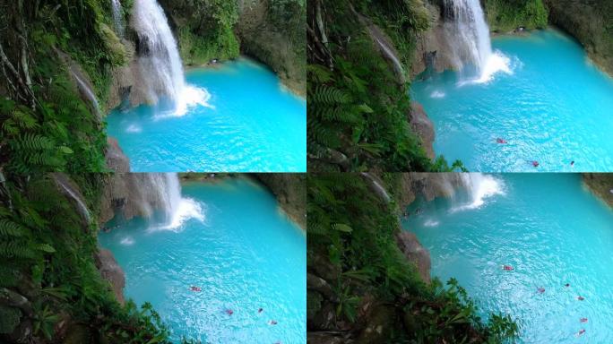 菲律宾宿雾岛卡瓦桑瀑布令人惊叹的瀑布。游客在泳池瀑布游泳。