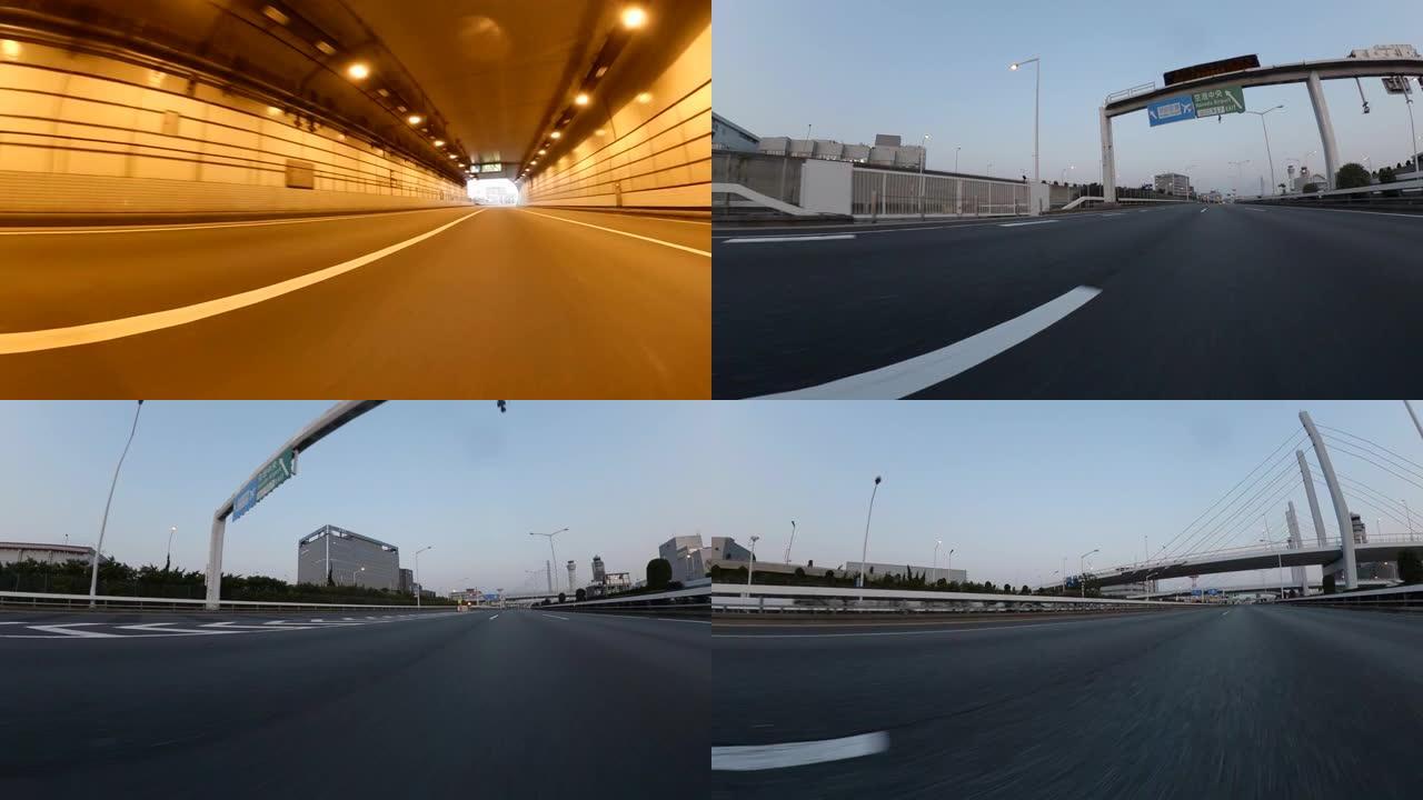 黄昏时在城市高速公路上行驶通过城市交通/在城市高速公路上拍摄的视角。驶向日落