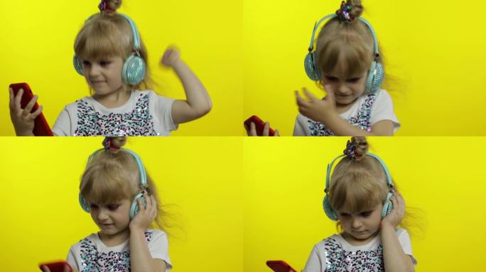 孩子用智能手机跳舞，用耳机听音乐。小女孩跳舞，有匈奴