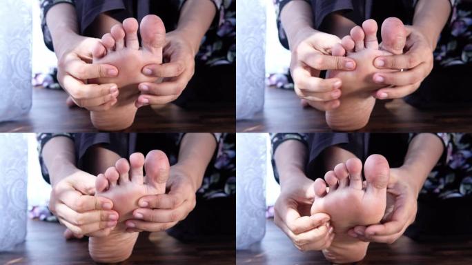 女人在疼痛中触摸脚特写。