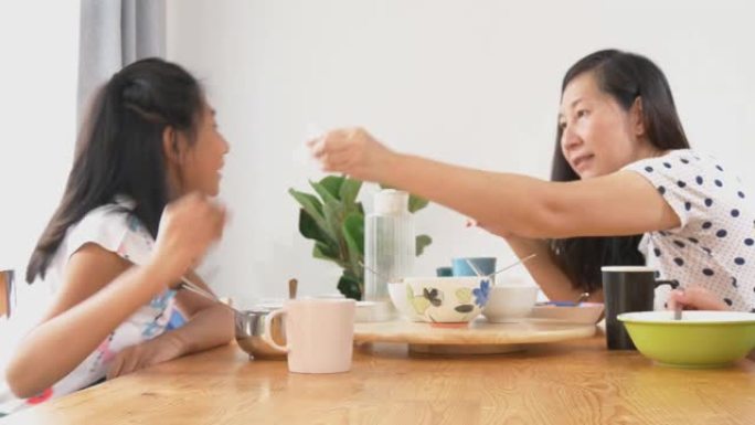 幸福的家庭在早上的时间吃饭，交谈和互相照顾，生活方式的概念。