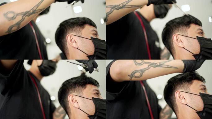 亚洲男性近距离侧视头部拍摄，男子在理发店理发时戴着黑色防护口罩。小型初创企业电晕病毒大流行新型冠状病