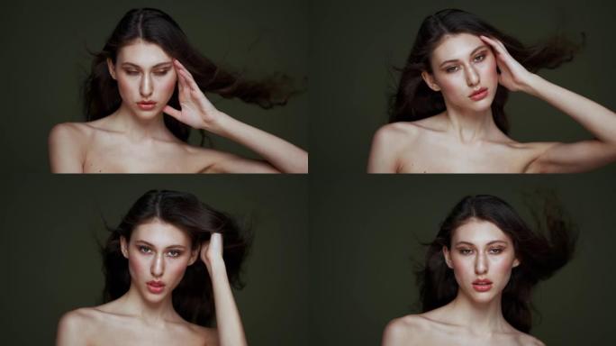 一个美丽的年轻女子，有着长长的黑色卷发，乳房肖像，裸露的肩膀。美丽的自然皮肤。红唇和优雅的手。女孩在