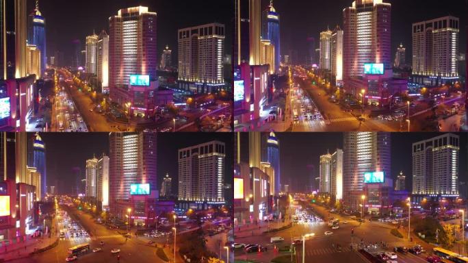 青岛市夜间照明市区繁忙交通街道十字路口空中全景4k中国