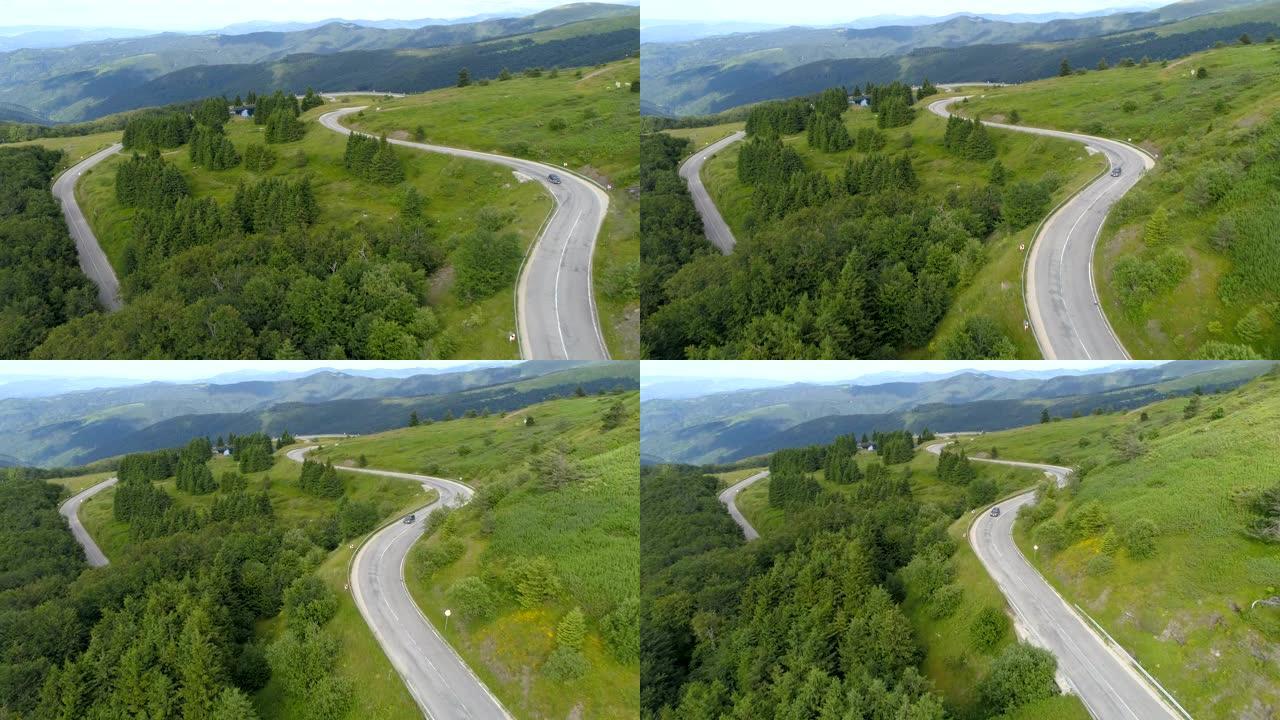 蜿蜒山区公路的鸟瞰图。无人机跟随SUV爬山通道