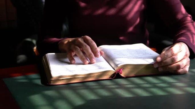 女人读圣经，特写镜头。手指一行一行地走。
