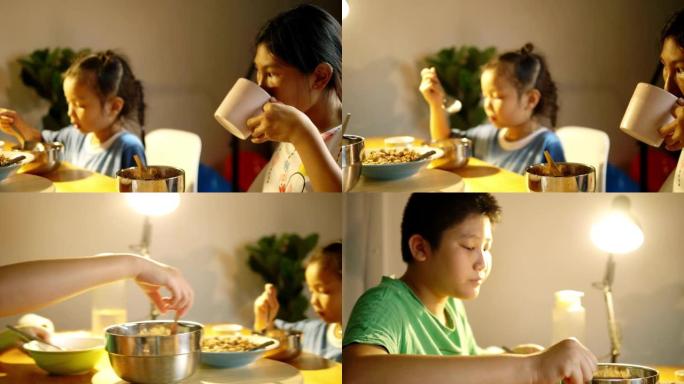 快乐的亚洲男孩和女孩晚上在家一起吃晚餐，生活方式理念。