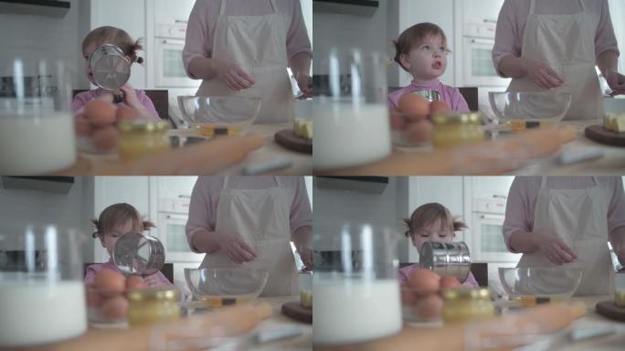 小女孩在碗里打碎鸡蛋做饼干面团