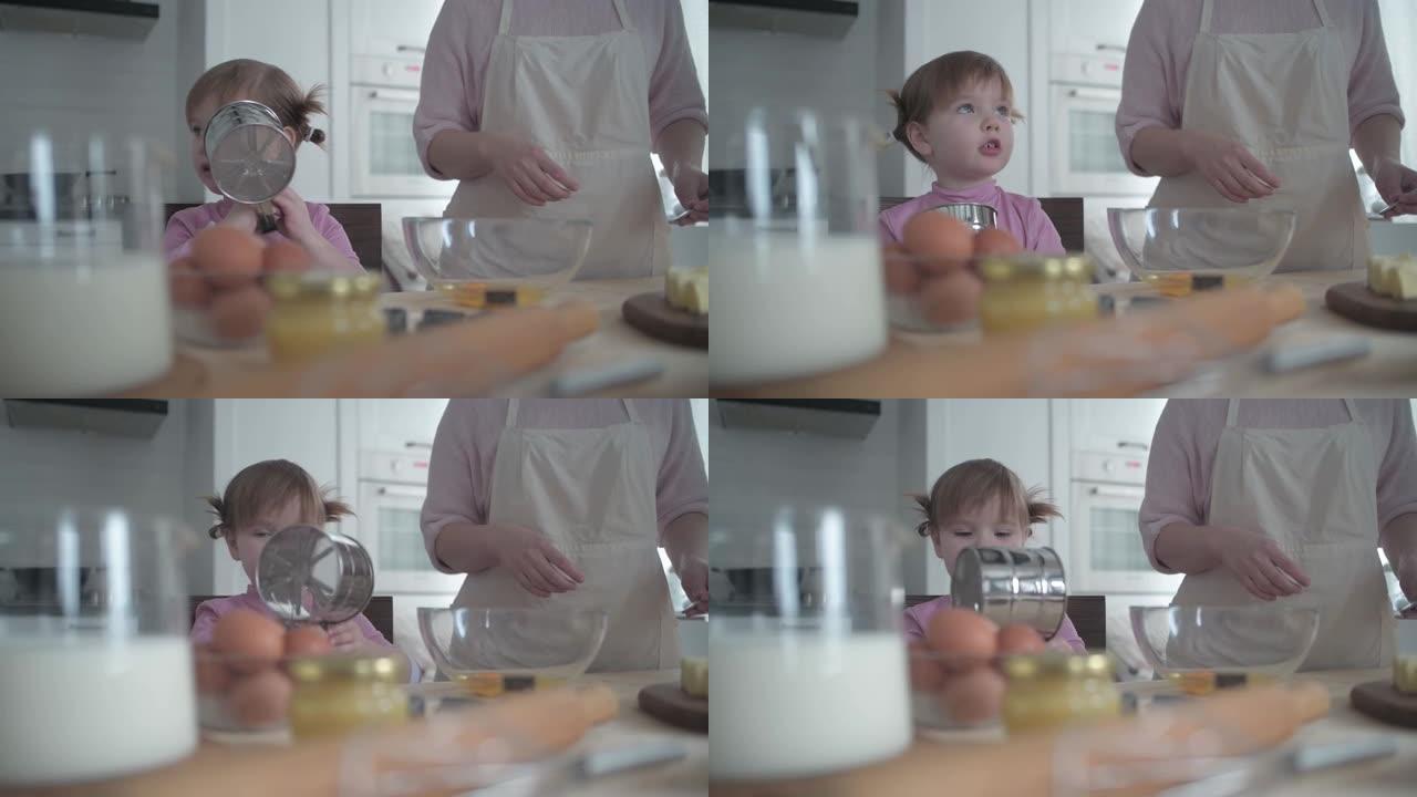 小女孩在碗里打碎鸡蛋做饼干面团