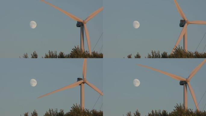 风车在蓝天上对着月亮旋转