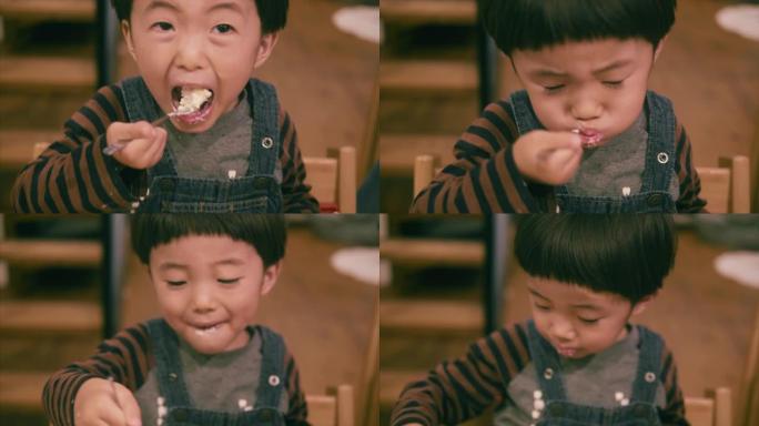 日本男孩在圣诞节期间吃草莓蛋糕