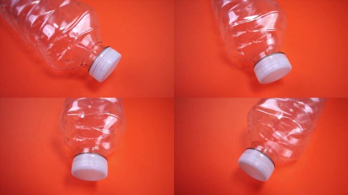 围绕橙色白色瓶盖的空塑料瓶运动