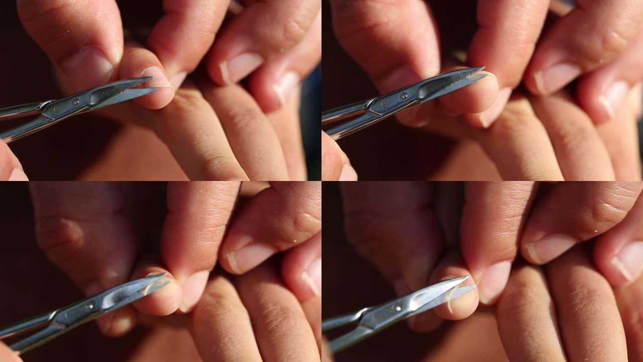修剪手钉特写。父母切孩子的指甲