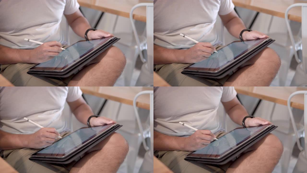 男人使用带平板电脑的数字铅笔。