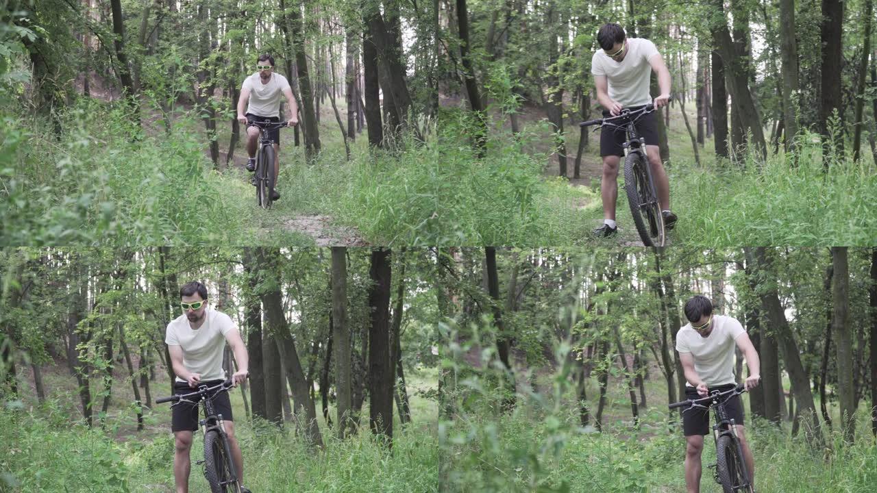 穿着运动服的男性在山地自行车上使用小工具在自行车电脑上导航。男子运动员在森林里锻炼，手里拿着全球定位