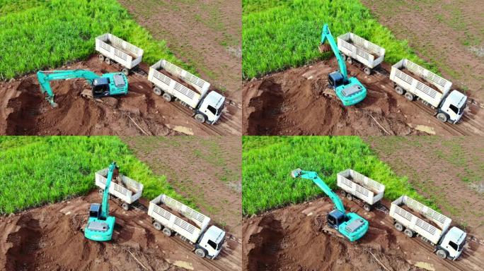 反铲将土壤装载到卡车中，然后卡车将土壤出售。