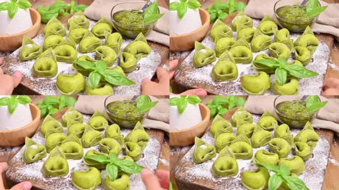 意大利。食物背景与自制的意大利意大利饺子和木质背景上的绿色香蒜酱成分。高角度视图。复制空间。