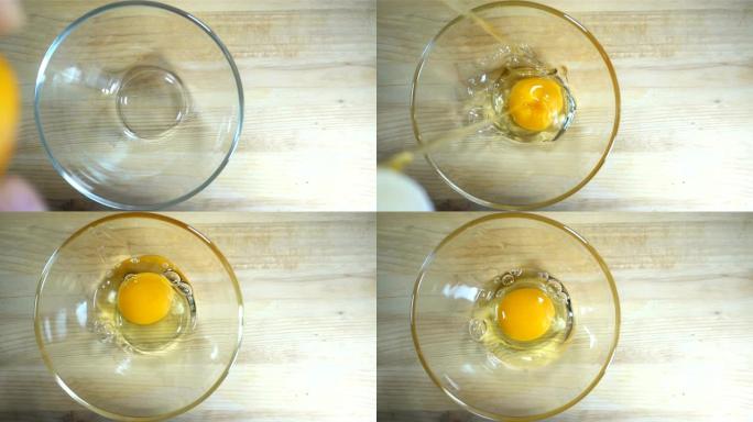 生鸡蛋以慢动作落入碗中。