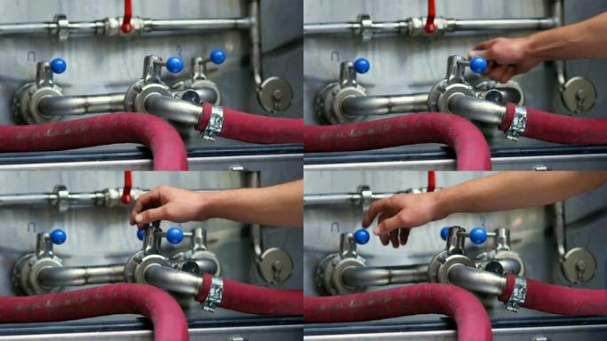 带橡胶管的锅炉系统保持蓝色水平的啤酒制造工人的作物视图