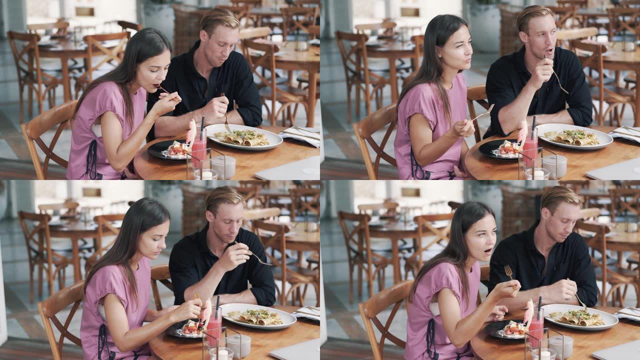 恋人男人和女人坐在户外咖啡馆里，吃健康的食物和聊天