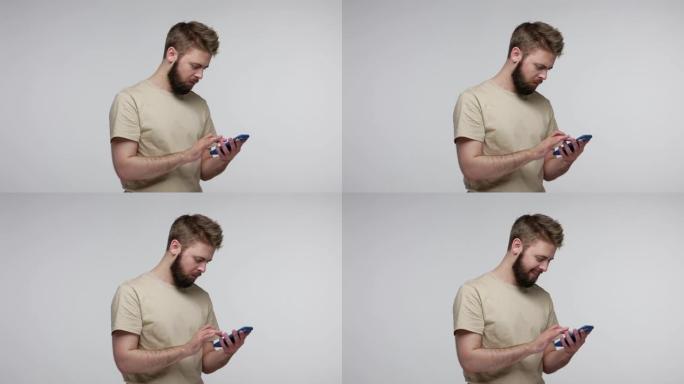 移动用户，专注的大胡子家伙用手机打字信息在线交流，网络聊天