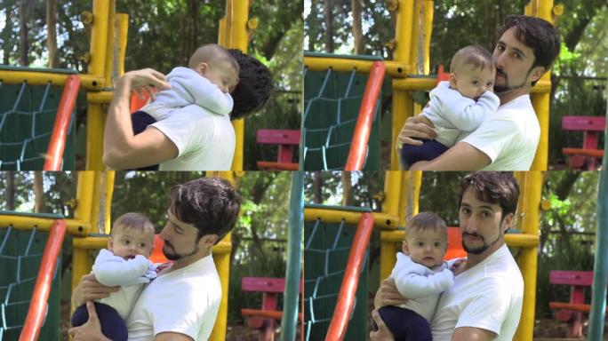 爸爸在户外游乐场公园抱着宝贝儿子，热爱真实的关系