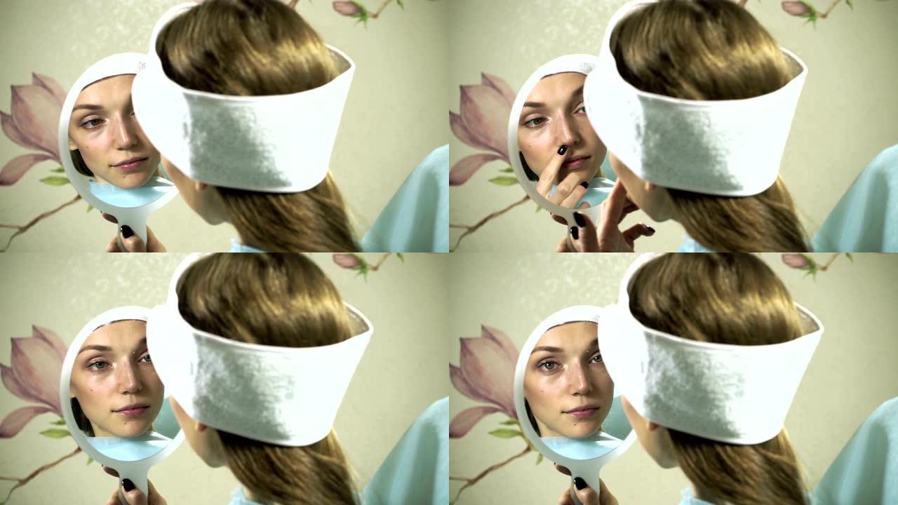鼻形矫正。女人看着镜子，检查整形手术后愈合的脸，效果惊人。高清