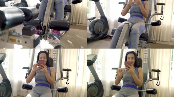 使用手机的年轻亚洲女性在健身馆向社交媒体拍照和发短信。