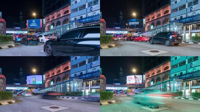 夜间，汽车在马来西亚城市街道的红绿灯处停下来。