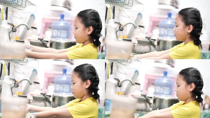 亚洲女孩学习如何在家厨房洗碗，生活方式理念。