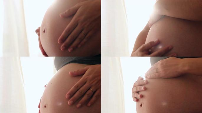 孕妇在窗户旁边摸肚子