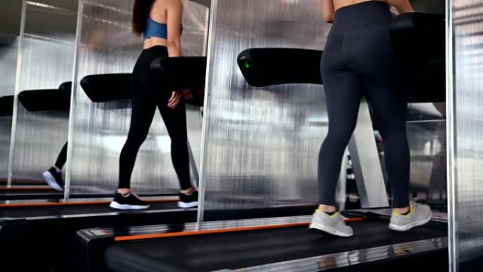 运动女性在跑步机上锻炼和跑步。亚洲女性在健身馆锻炼和生活方式。健美健康。